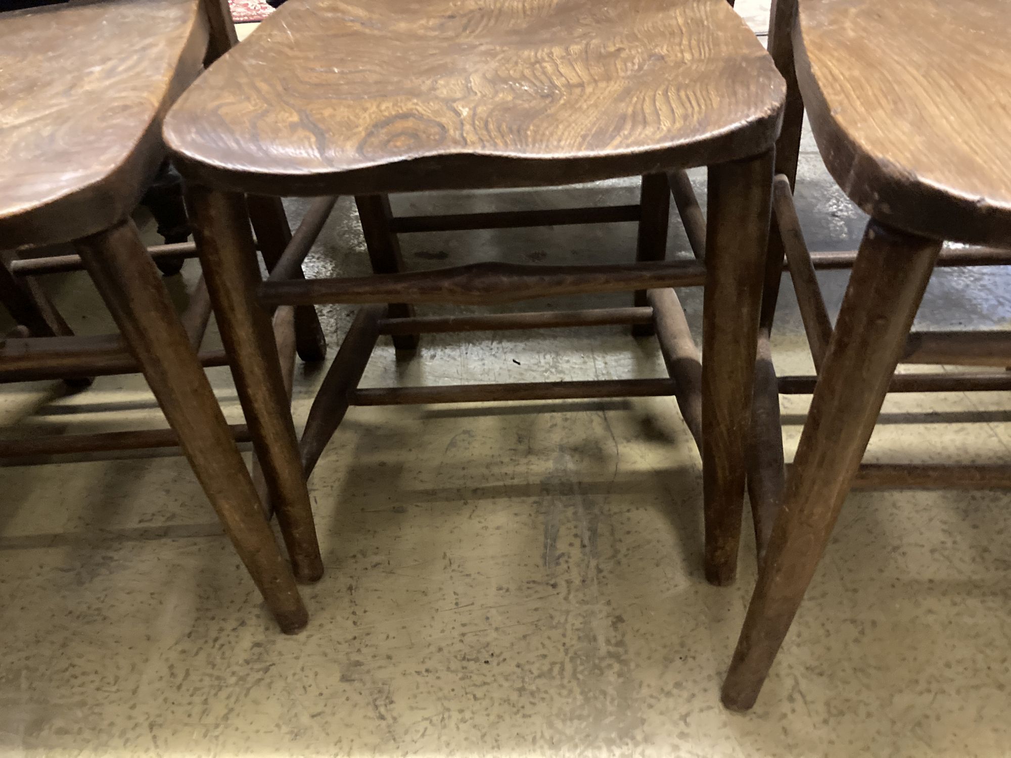 A set of four late Victorian elm and beech chapel chairs.